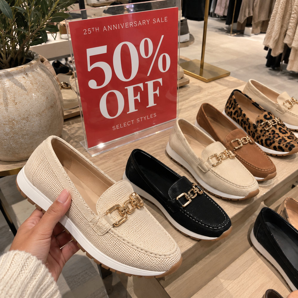 Loafer sneakers on a store display with a 25th Anniversary Sale sign